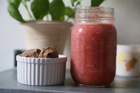 Daily harvest bites next to a blended smoothie in mason jar